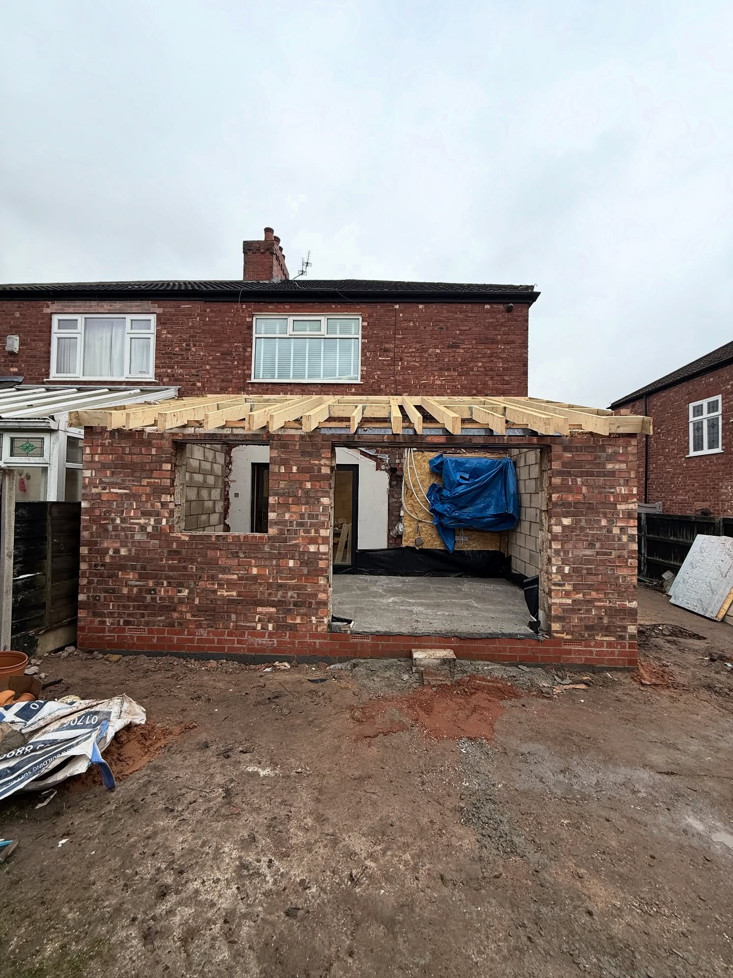 Rear house extension shell mid-build with timber roof structure