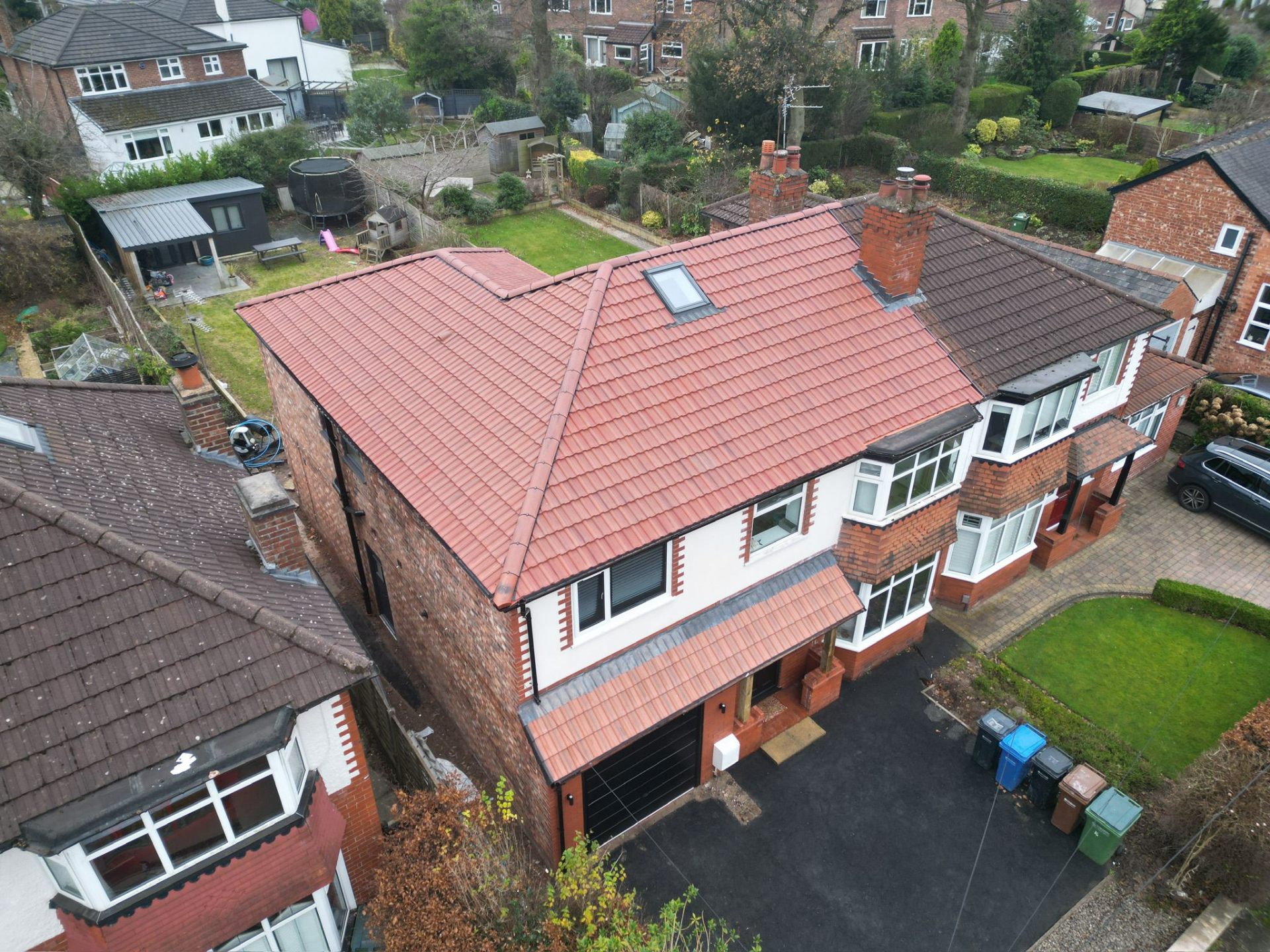 Aerial drone view of new red clay-tile roof and rear loft dormer on a Manchester semi
