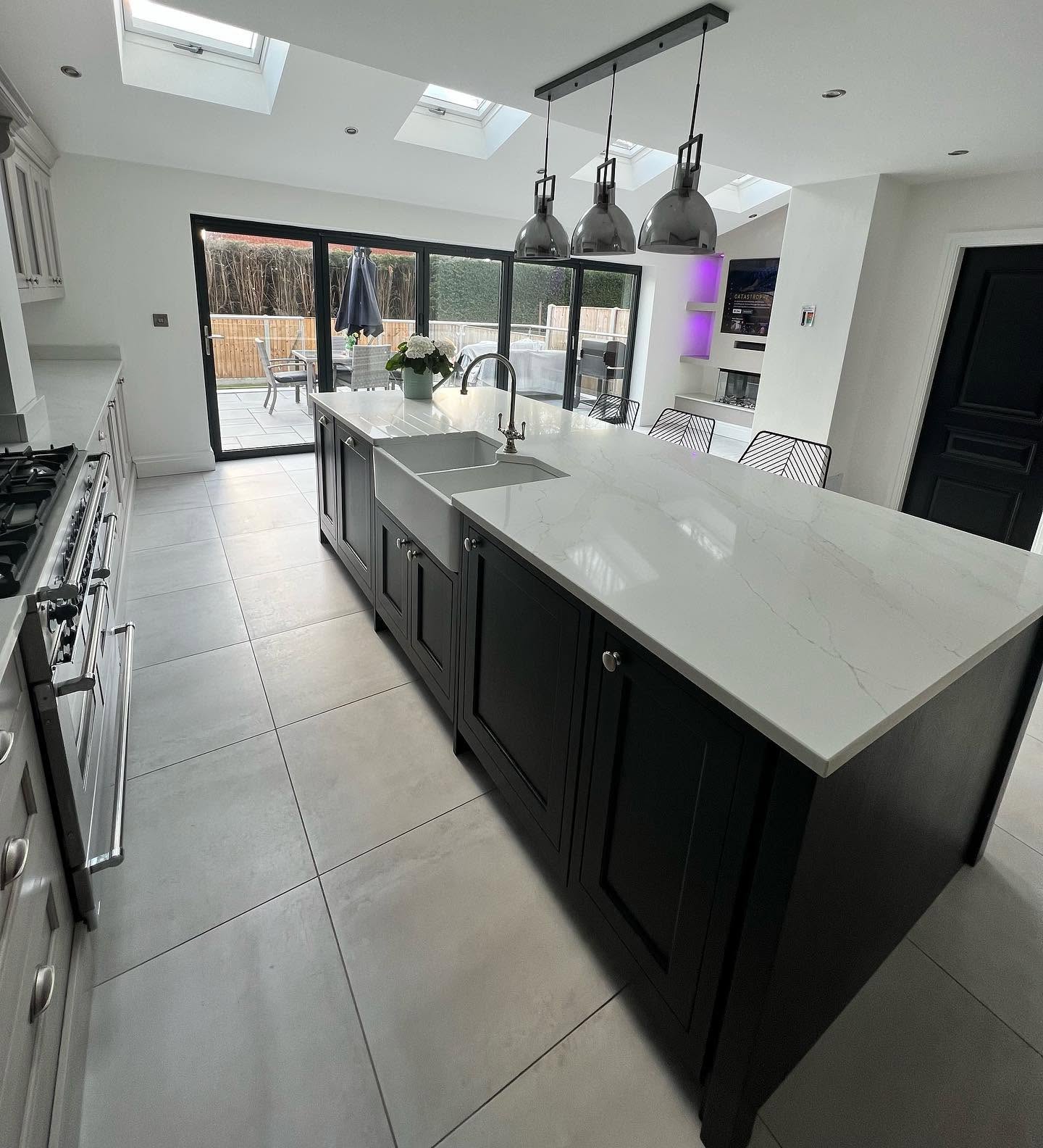Painted kitchen with marble island and pendant lighting