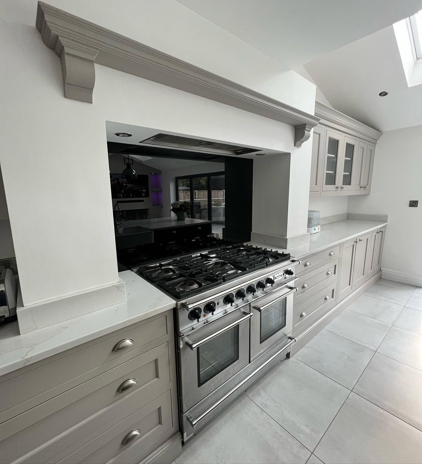 Dark Shaker kitchen with quartz island and bifold doors