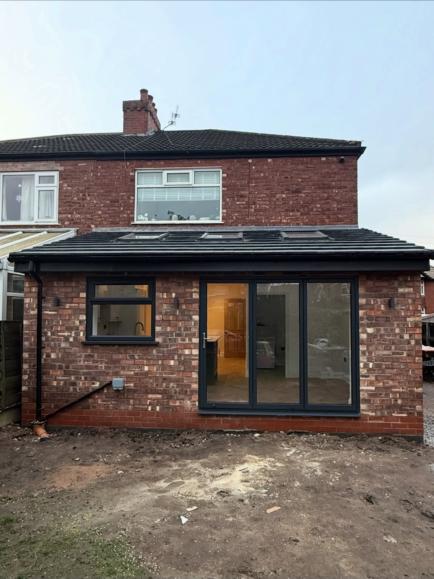 Finished rear extension with bifold doors on a Manchester semi